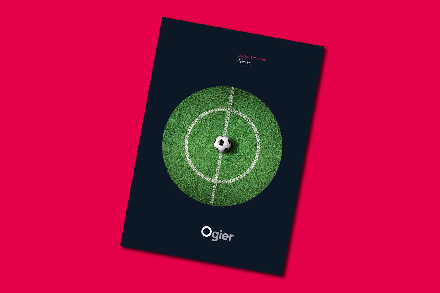 Ogier Ireland Sports Brochure cover with top-down view of a green football pitch centre circle, shown inside a dark circular frame