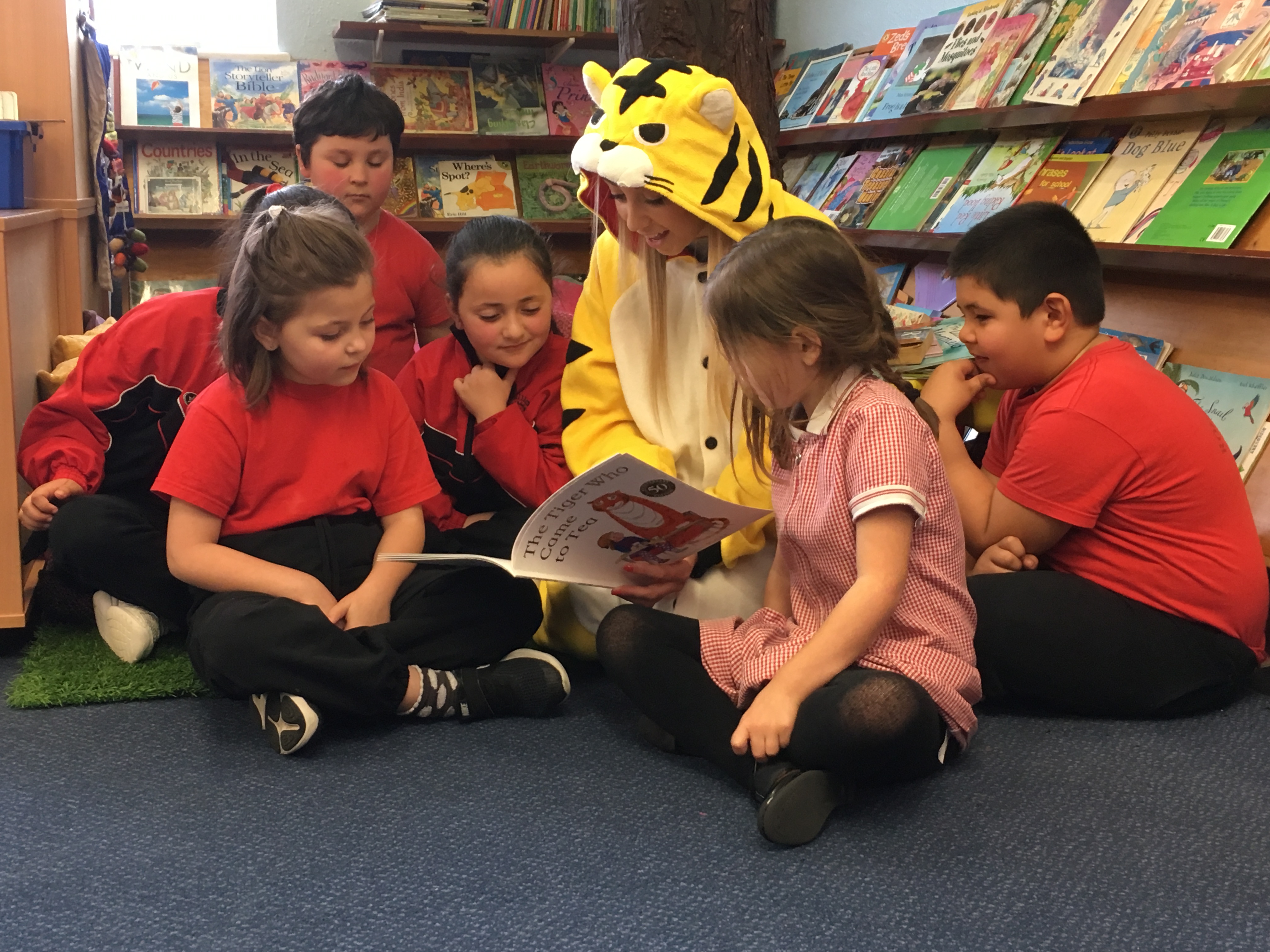 Photo of Ogier staff reading to school children