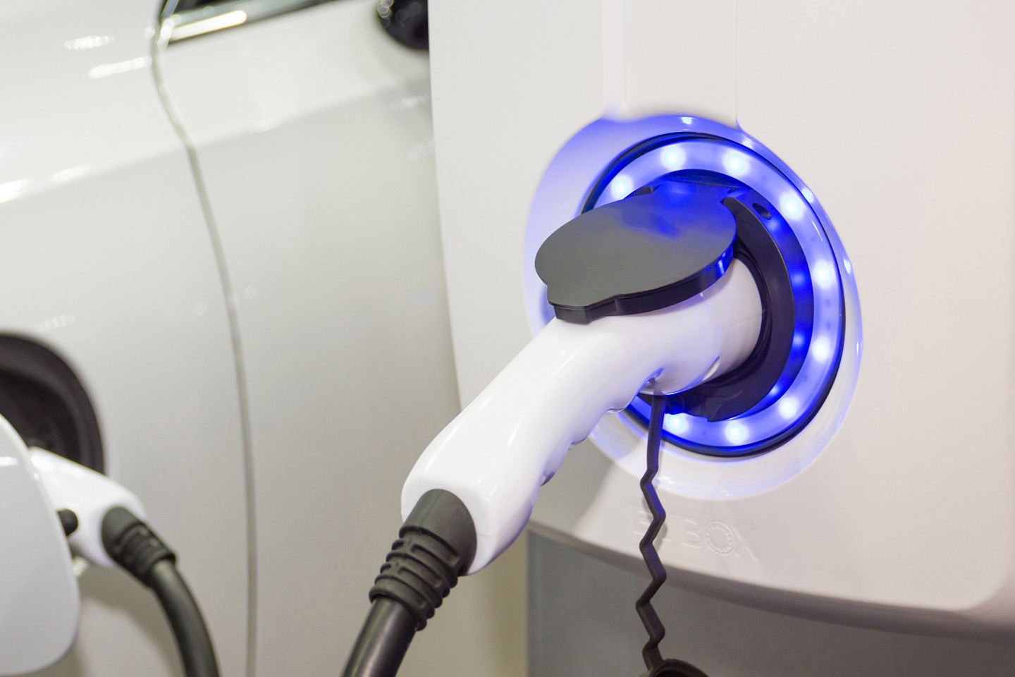 close up of purple electric car charger plugged in