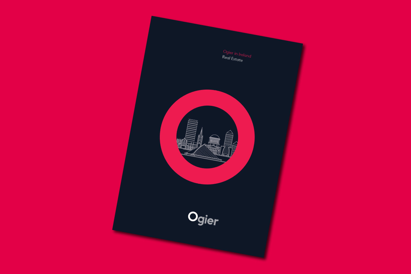 Ogier Ireland Real Estate brochure cover featuring stylised cityscape illustration inside a bold pink circle with Ogier branding on dark background