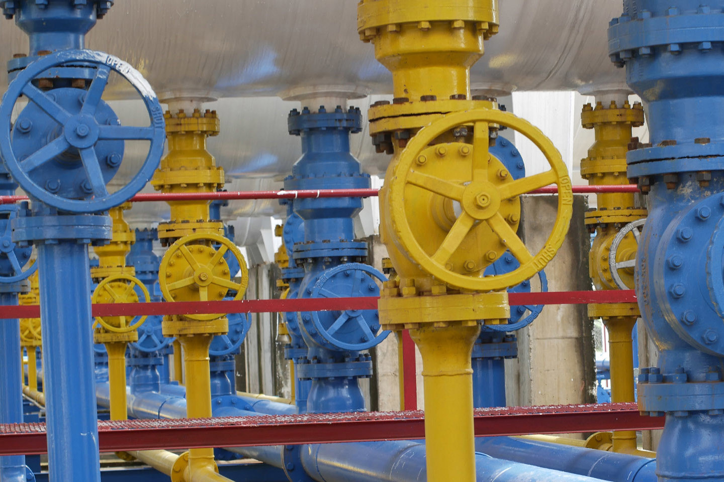 industrial blue and yellow machinery used in gas production
