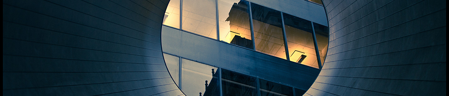 Reflection on high rise building windows through a tube