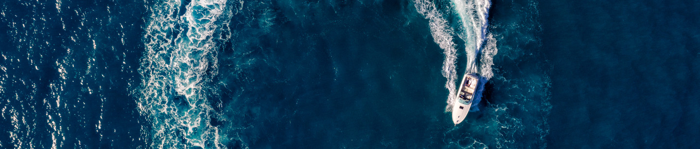 Aerial shot of speedboat creating 'O' in the sea